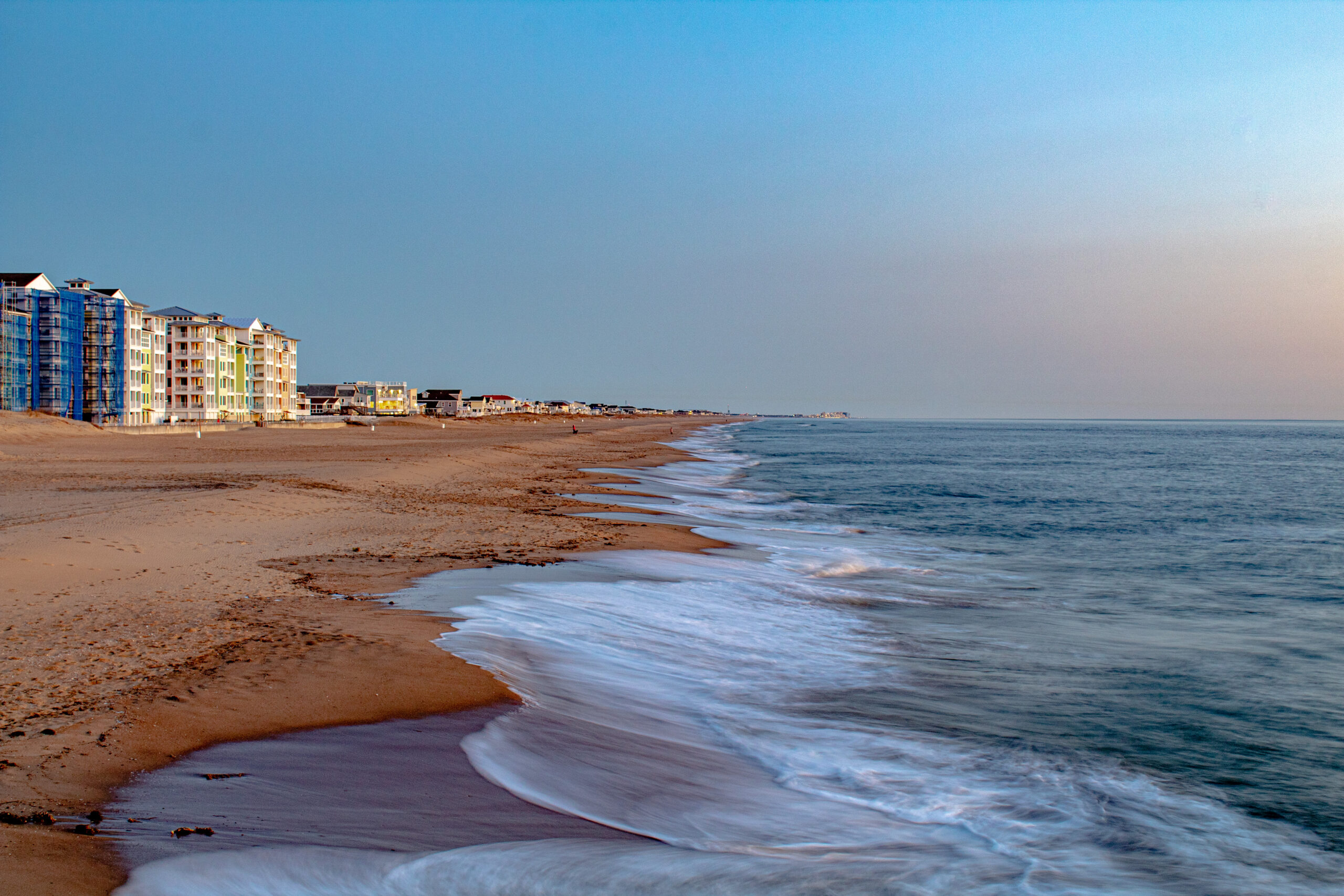 Sunrise over Virginia Beach oceanfront condos and sandy beach
